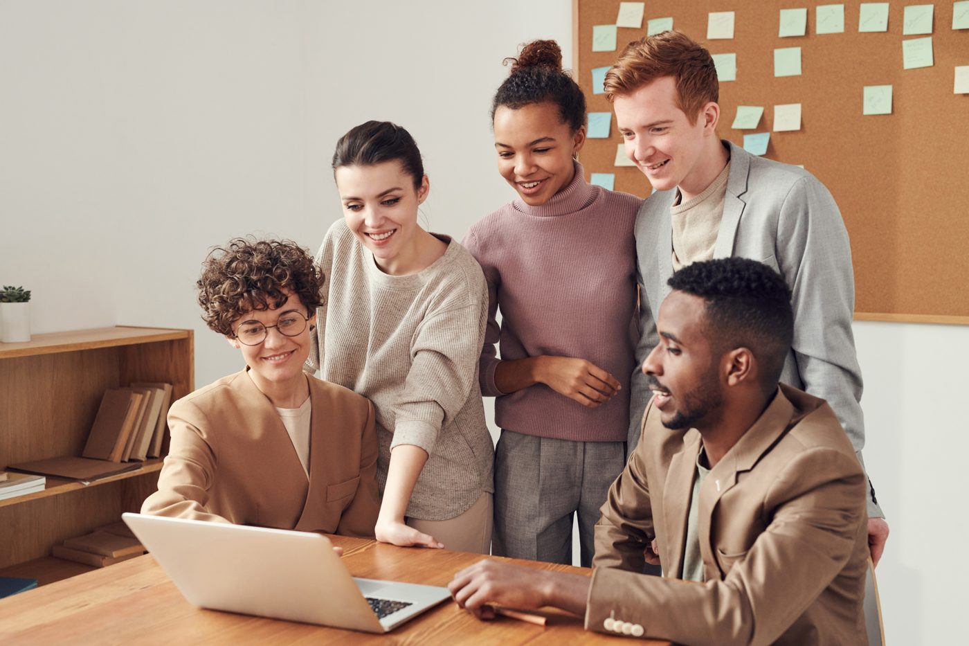 A group working together around a laptop