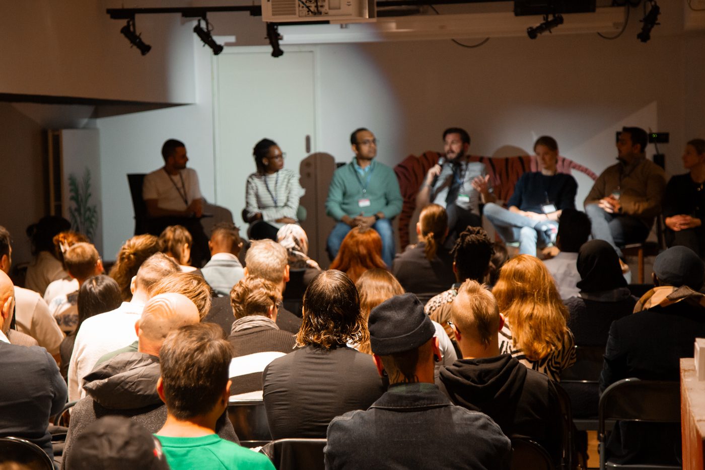 A panel talk in front of a full room